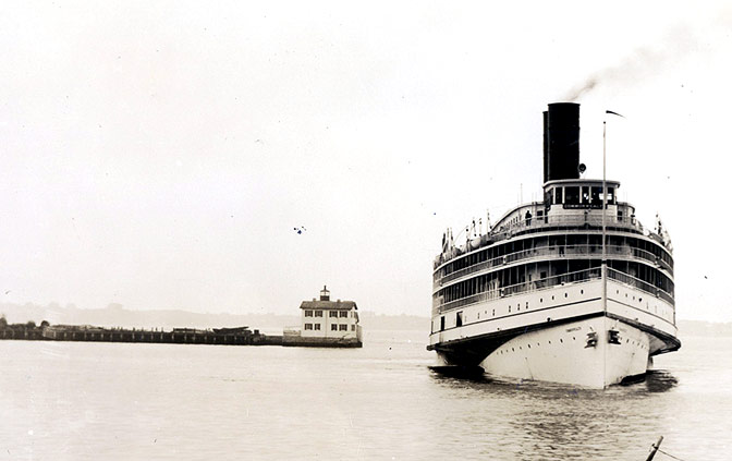 SS Commonwealth passing the Newport Harbor Light